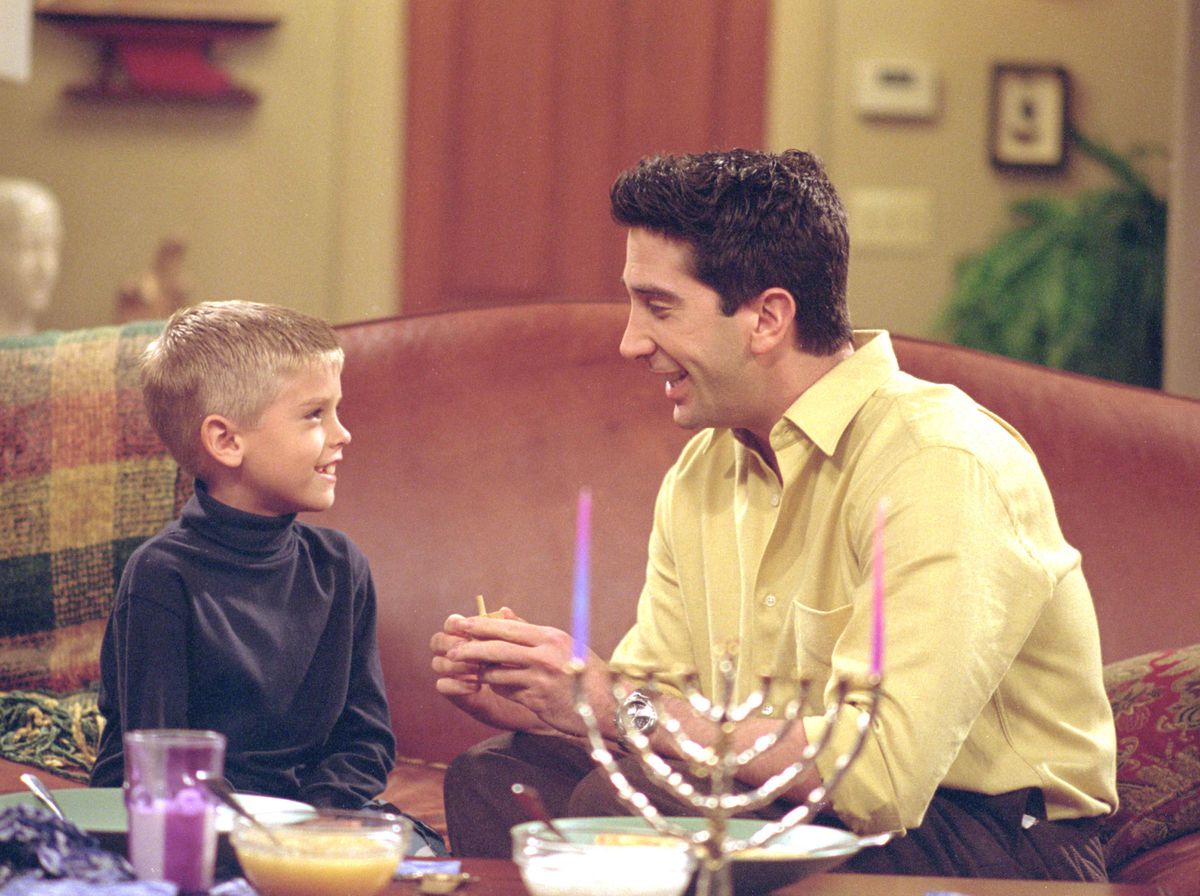 Ross — free of his Holiday Armadillo garb — discusses Hanukkah with his son Ben