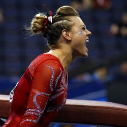 Utah's Tiffani Lewis celebrates after competing on the vault during the NCAA women's gymnastics championships Friday, April 14, 2017, in St. Louis. (AP Photo/Jeff Roberson)