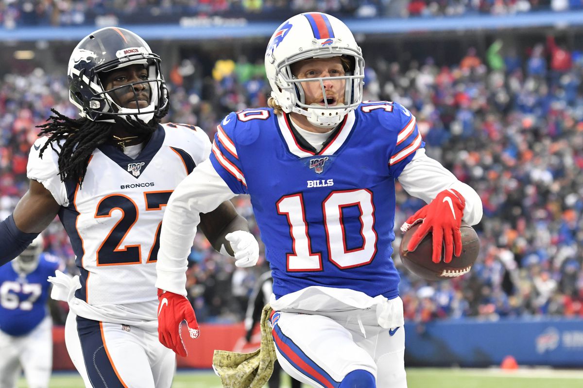 Buffalo Bills wide receiver Cole Beasley reacts to scoring a touchdown in front ofDenver Broncos cornerback Davontae Harris in the third quarter at New Era Field.
