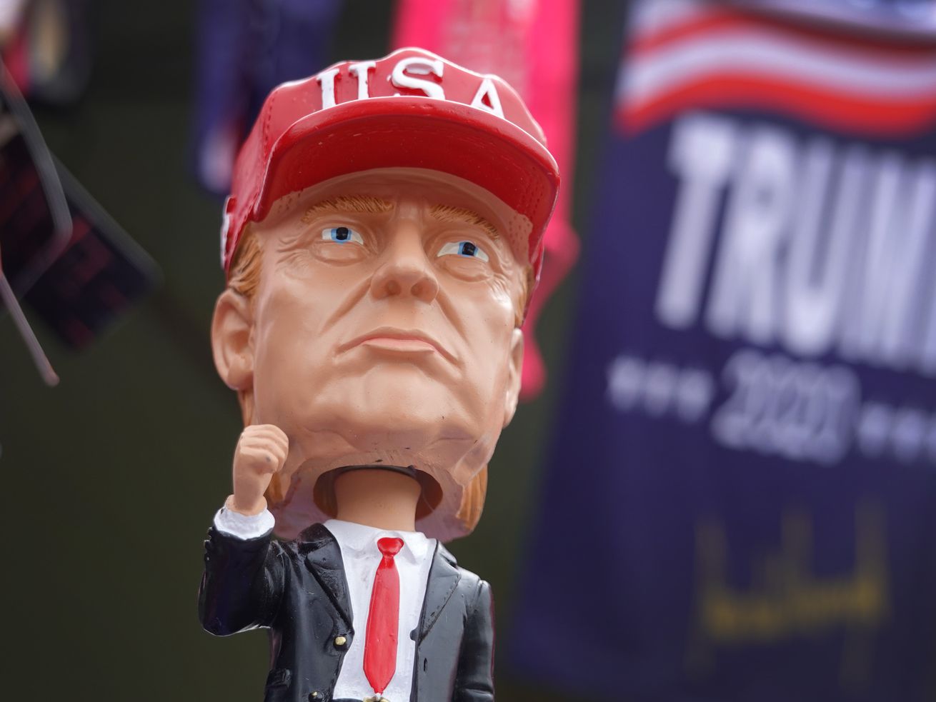 A Trump bobblehead wearing a USA cap.