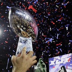 New England Patriots players celebrate with the Vince Lombardi Trophy after the NFL Super Bowl XLIX football game against the Seattle Seahawks Sunday, Feb. 1, 2015, in Glendale, Ariz. The Patriots won 28-24. (AP Photo/David J. Phillip)