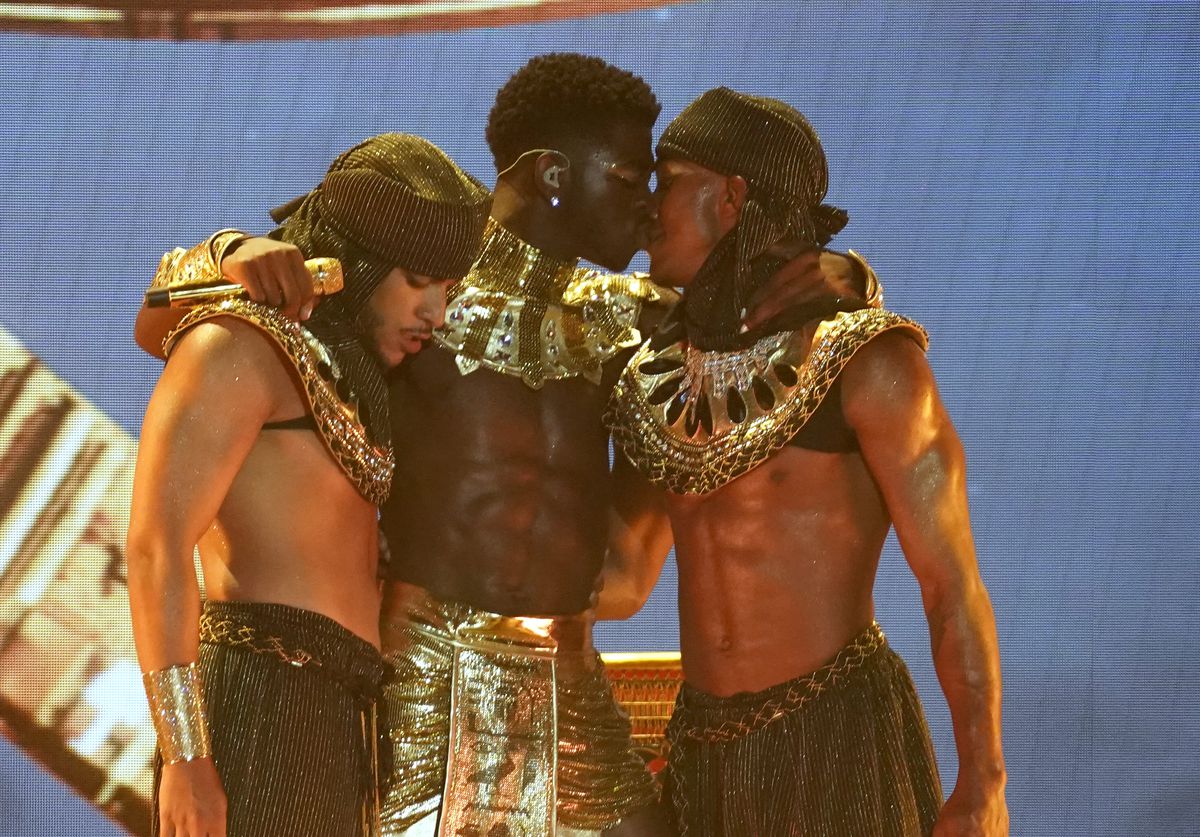 Lil Nas X (center) kisses a dancer at the conclusion of his performance at the BET Awards on Sunday night at the Microsoft Theater in Los Angeles.