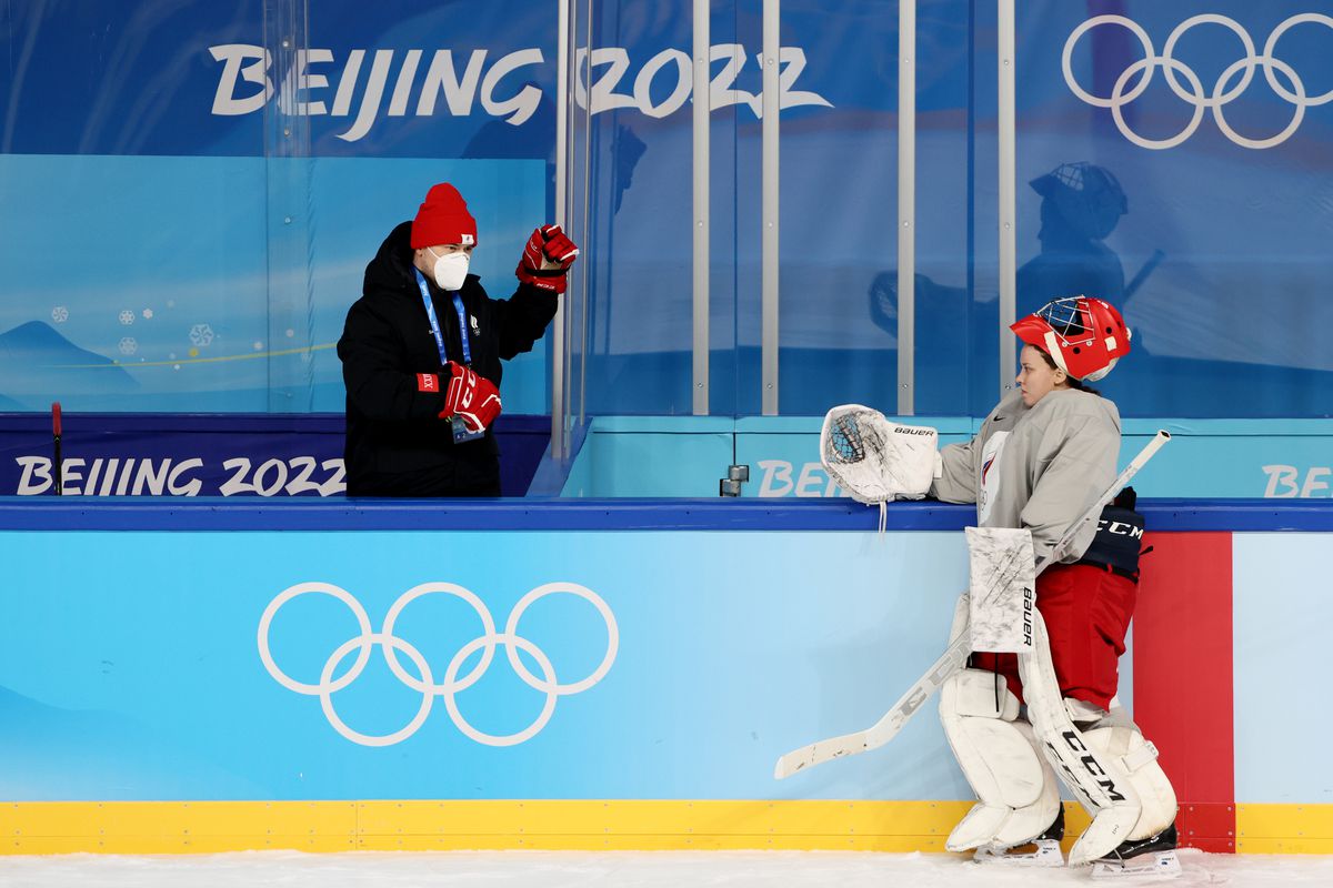 A coach approaches goaltender Maria Sorokina (R) during a training session of the ROC women’s ice hockey team at the Wukesong Arena (Cadillac Centre) ahead of the 2022 Winter Olympics.