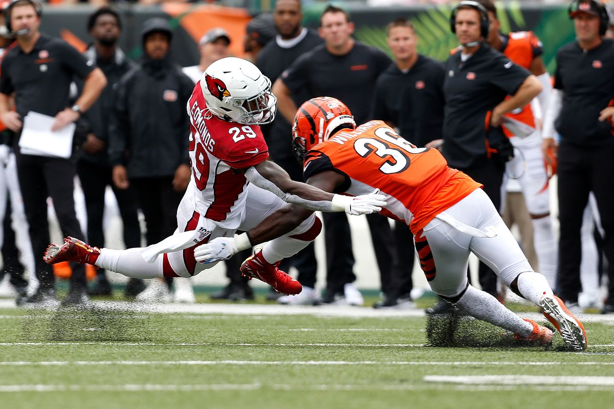 Chase Edmonds of the Arizona Cardinals is tackled by Shawn Williams of the Cincinnati Bengals during the second quarter at Paul Brown Stadium on October 6, 2019 in Cincinnati, Ohio.