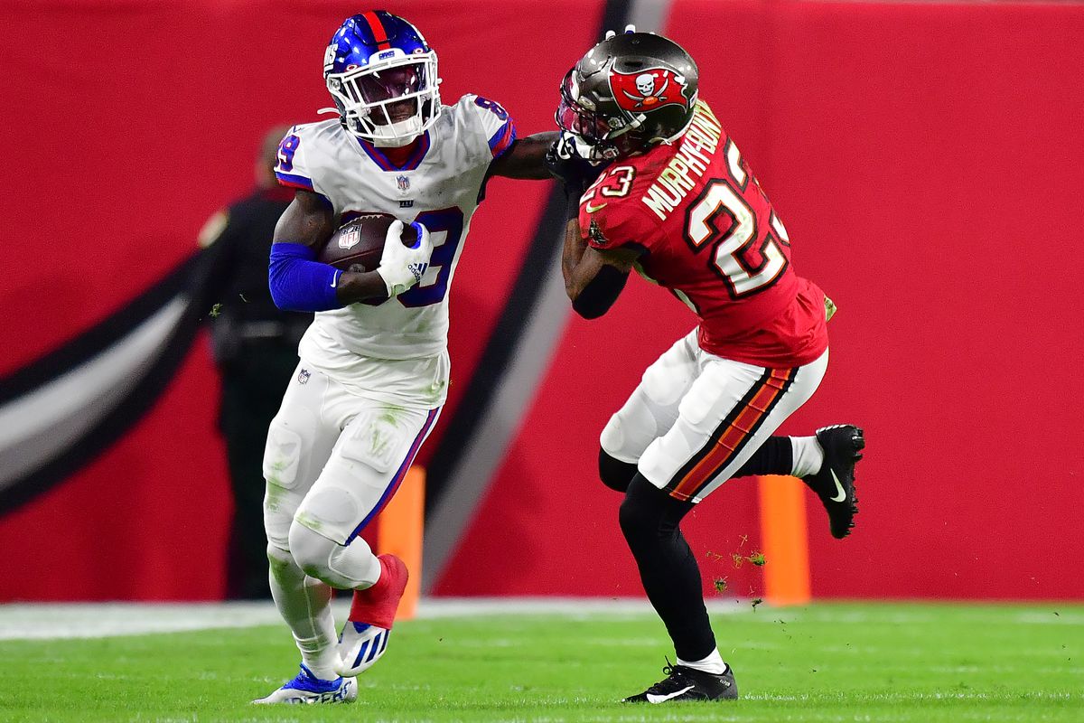 Kadarius Toney #89 of the New York Giants carries the ball after a reception as Sean Murphy-Bunting #23 of the Tampa Bay Buccaneers defends during the third quarter at Raymond James Stadium on November 22, 2021 in Tampa, Florida.