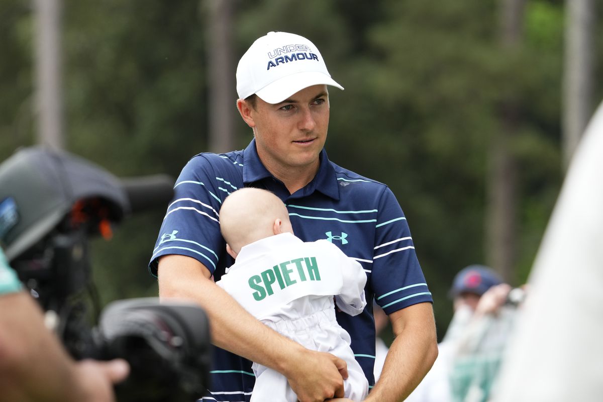 Jordan Spieth holds his daughter Sammy after finishing the Par 3 Competition at The Masters golf tournament at Augusta National Golf Club.
