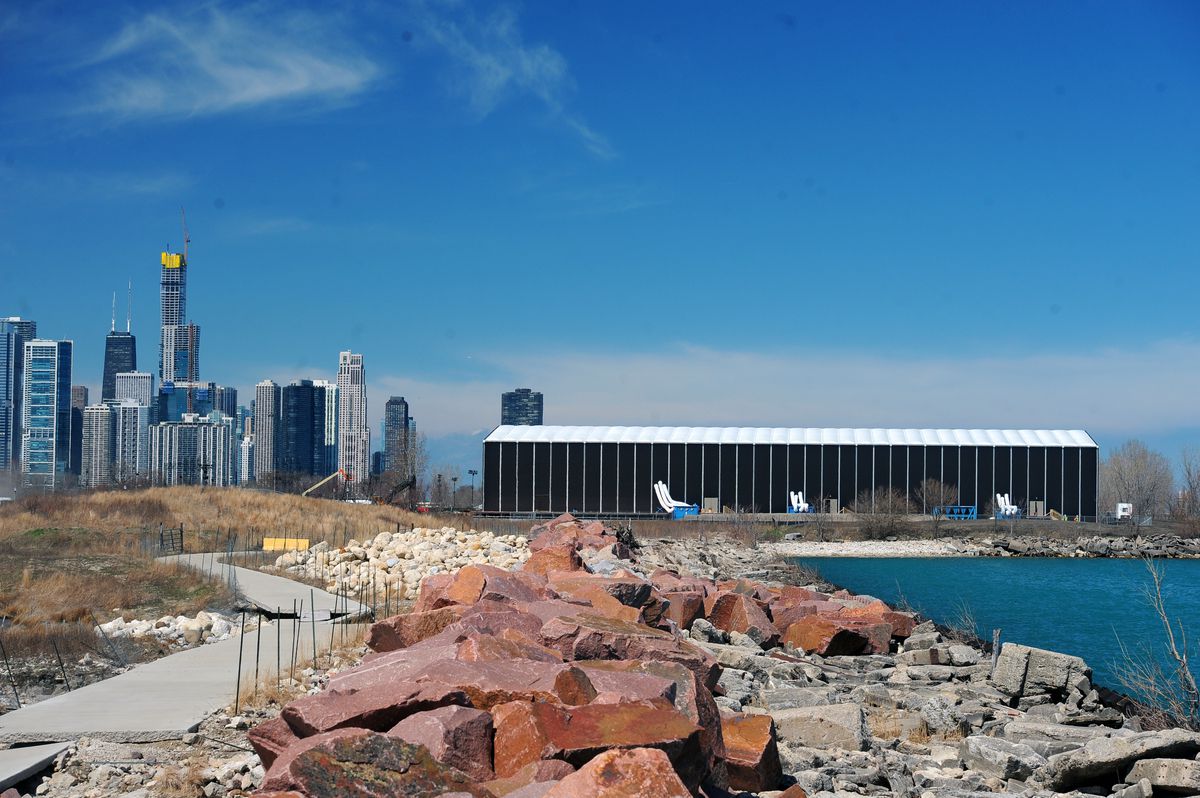 The exhibition’s giant steel structure for “Hamilton: The Exhibition,” on Chicago’s Northerly Island is pictured in the distance during its construction phase on April 9. | Victor Hilitski/For the Sun-Times