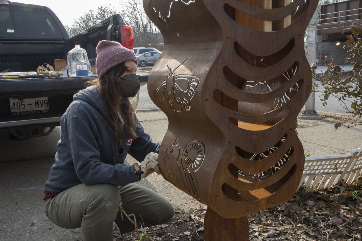 Emily Moorhead-Wallace filling up the sculpture with wood and other natural materials that will attract pollinators to nest. Friday, December 10, 2021 