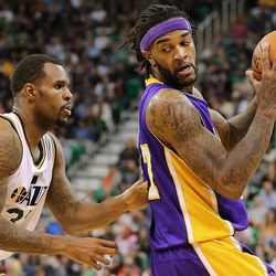 Utah Jazz forward Trevor Booker (33) defends Los Angeles Lakers center Jordan Hill (27) as the Jazz and the Lakers play Wednesday, Feb. 25, 2015, at EnergySolutions Arena in Salt Lake City.