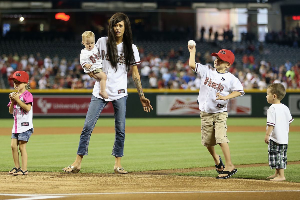  (L-R) Shiloh, Julianne Ashcraft, wife to fallen firefighter Andrew Ashcraft, Ryder and Tate Andrew throw out the first pitch before tonight's game.
