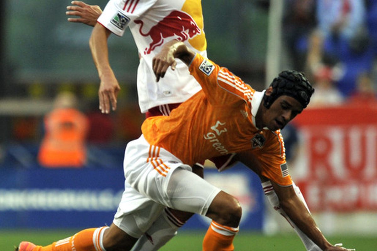 May 9, 2012; Harrison, NJ, USA;  New York Red Bulls midfielder Mehdi Ballouchy (10) fouls Houston Dynamo midfielder Calen Carr (3) during the first half at  Red Bull Arena.   Mandatory Credit: Joe Camporeale-US PRESSWIRE