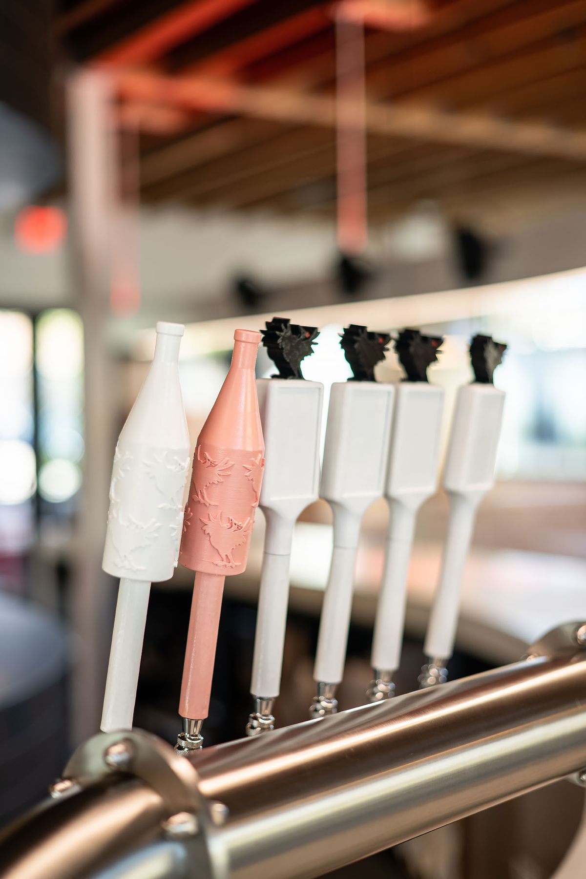 Pink and white taps for wine and beer at Howlin’ Ray’s in Pasadena, California.