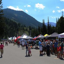 Fans gather prior to riders arriving in the Tour of Utah cycling race for the finish of Stage 6 at Snowbird ski area on Saturday, Aug. 5, 2017.