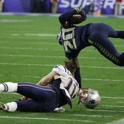 New England Patriots wide receiver Julian Edelman (11) tackles Seattle Seahawks cornerback Jeremy Lane (20) after an interception during the first half of NFL Super Bowl XLIX football game Sunday, Feb. 1, 2015, in Glendale, Ariz.