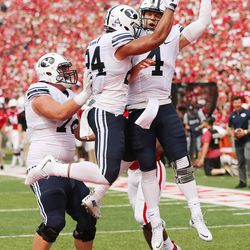 Brigham Young Cougars quarterback Taysom Hill (4) celebrates his touchdown with Brigham Young Cougars running back AJ Moore (34) against Nebraska in Lincoln, Neb., Saturday, Sept. 5, 2015.