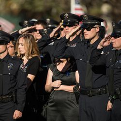 Police officers give a final salute during the graveside service for West Valley police officer Cody Brotherson at Valley View Cemetery in Valley View Memorial Park on Monday, Nov. 14, 2016.