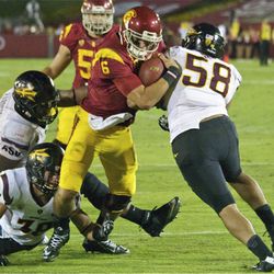 USC quarterback Cody Kessler battles through two tackles to score a touchdown on an 8-yard run.
