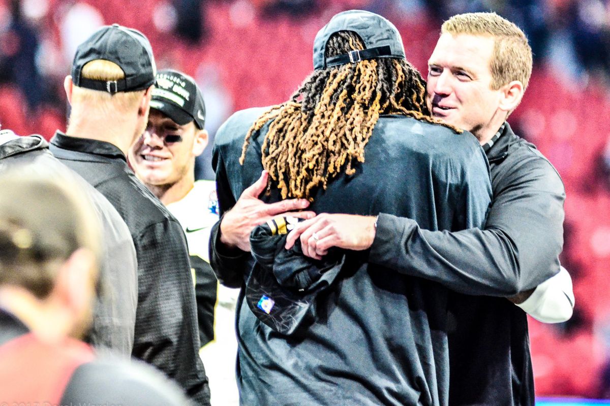 UCF A.D. Danny White embraces Shaquem Griffin after the Knights' victory over Auburn in the 2018 Chick-Fil-A Peach Bowl. (Photo: Derek Warden)