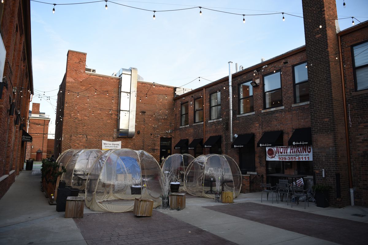 Five plastic tent domes sit on the back courtyard patio outside of Qahwah House in Dearborn.