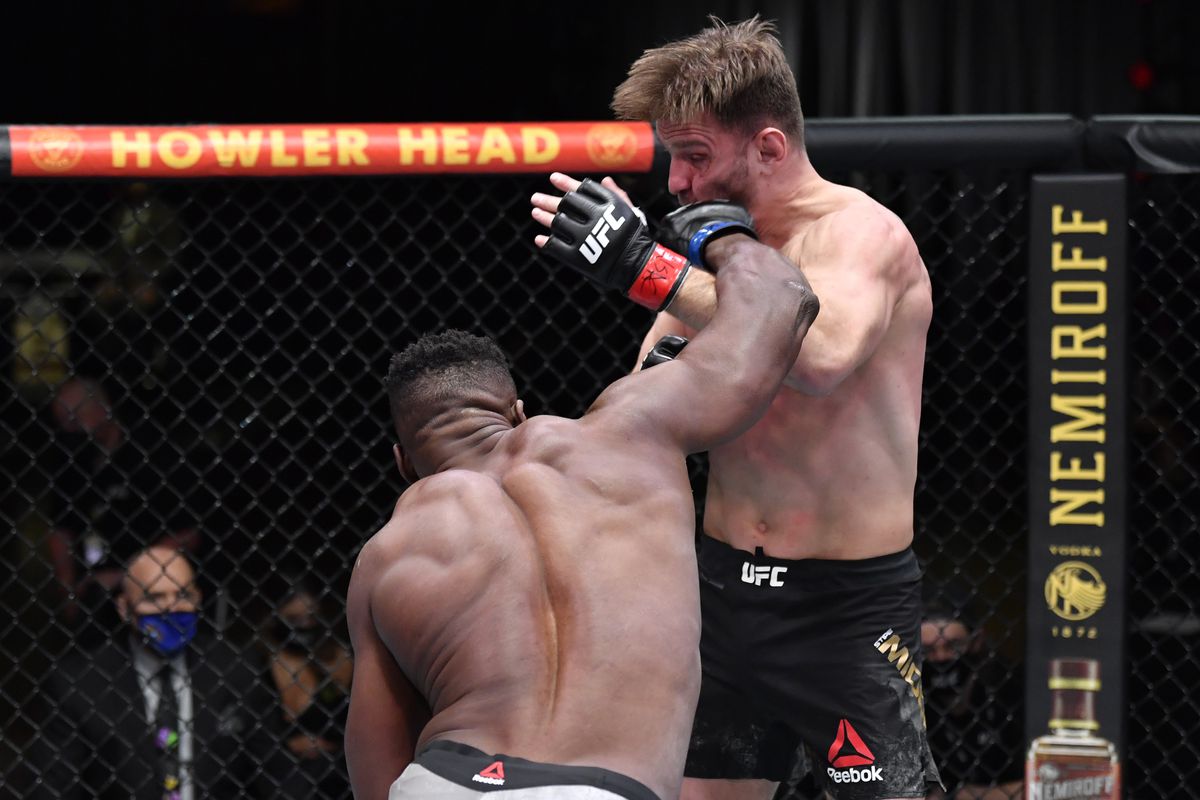 Francis Ngannou of Cameroon punches Stipe Miocic in their UFC heavyweight championship fight during the UFC 260 event at UFC APEX on March 27, 2021 in Las Vegas, Nevada.