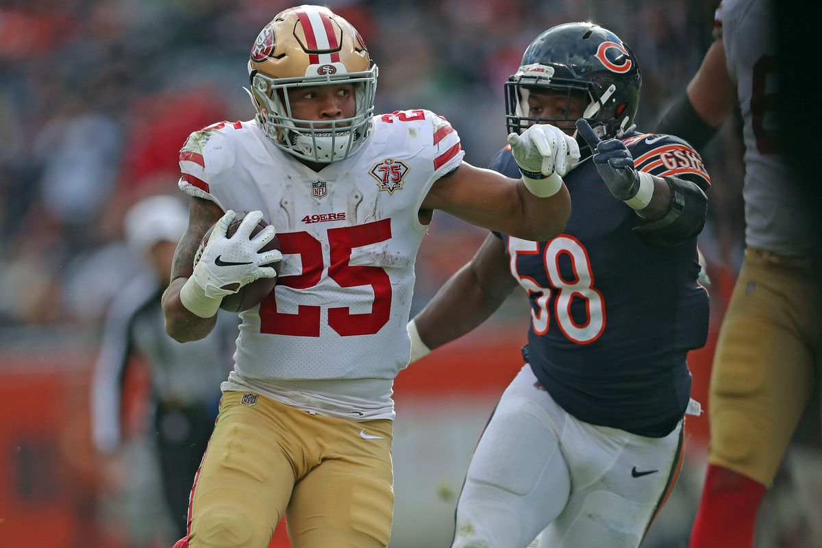 San Francisco 49ers running back Eli Mitchell (25) runs past Chicago Bears inside linebacker Roquan Smith (58) during the second half at Soldier Field.