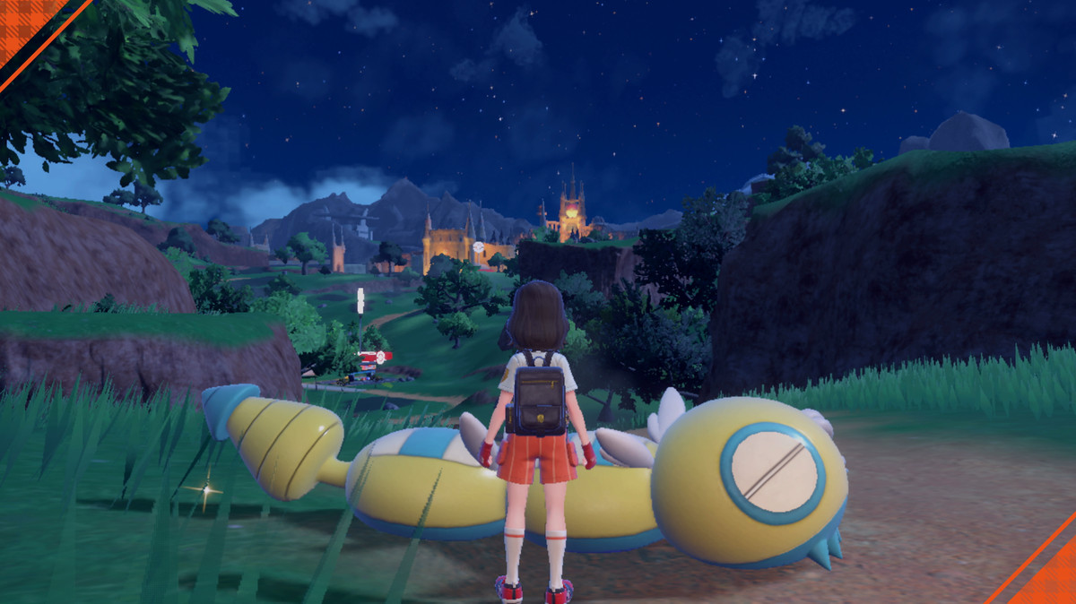 A screenshot of a Dudunsparce at a picnic in Pokémon Scarlet and Violet. It is laying on the ground and makes the trainer look small in comparison. It has four segments total.