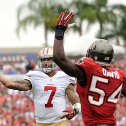 San Francisco 49ers quarterback Colin Kaepernick (7) gets away from Tampa Bay Buccaneers outside linebacker Lavonte David (54) as he throws a touchdown pass to wide receiver Michael Crabtree during the first quarter of an NFL football game, Sunday, Dec. 15, 2013, in Tampa, Fla. 