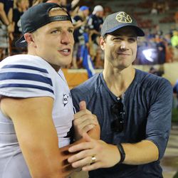 BYU quarterback, Taysom Hill is congratulated by former Cougar Jimmer Fredette after BYU defeated Texas Saturday, Sept. 6, 2014, in Austin, Texas, 41-7.