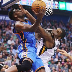 Oklahoma City Thunder forward Jerami Grant (9) is fouled by Utah Jazz forward Derrick Favors (15) under the basket as the Jazz and the Thunder play at Vivint Smart Home arena in Salt Lake City on Wednesday, Dec. 14, 2016.