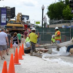 2:14 p.m. Pedestrians pass by as workers pour concrete at Addison and Sheffield - 