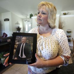 FILE - In this July 13, 2016 file photo, Laurie Holt holds a photograph of her son Joshua Holt, who has been jailed in Venezuela, at her home in Riverton, Utah. Venezuela’s chief prosecutor has requested the conditional release of the Utah man and his wife detained for over a year on weapons charges. announced on Friday, July 14, 2017.