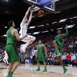 Utah Utes forward David Collette dunks the ball with three Oregon defenders around him during the Pac-12 basketball tournament in Las Vegas on Thursday, March 8, 2018.