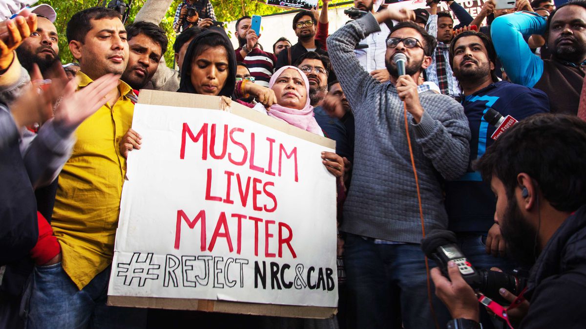 A protester holds a sign that says “Muslim Lives Matter #Reject NRC&amp;CAB” in New Delhi, India.