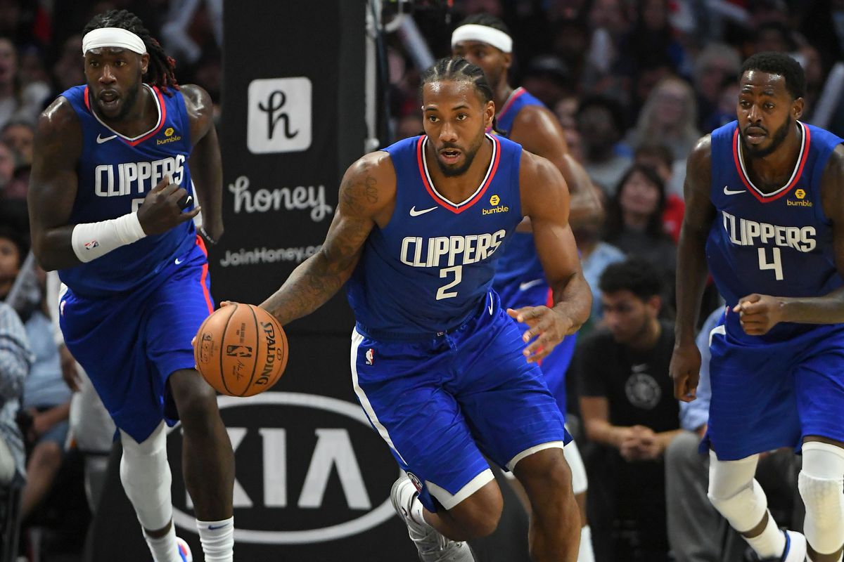 Los Angeles Clippers forward Kawhi Leonard dribble up court as forward Montrezl Harrell and forward JaMychal Green react in the second half of the game against the Utah Jazz at Staples Center.