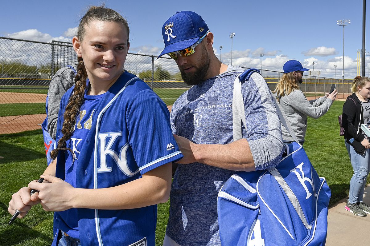 Kansas City Royals outfielder Alex Gordon autographs the back of a jersey for a fan during spring training on February 18, 2019, in Surprise, Ariz.