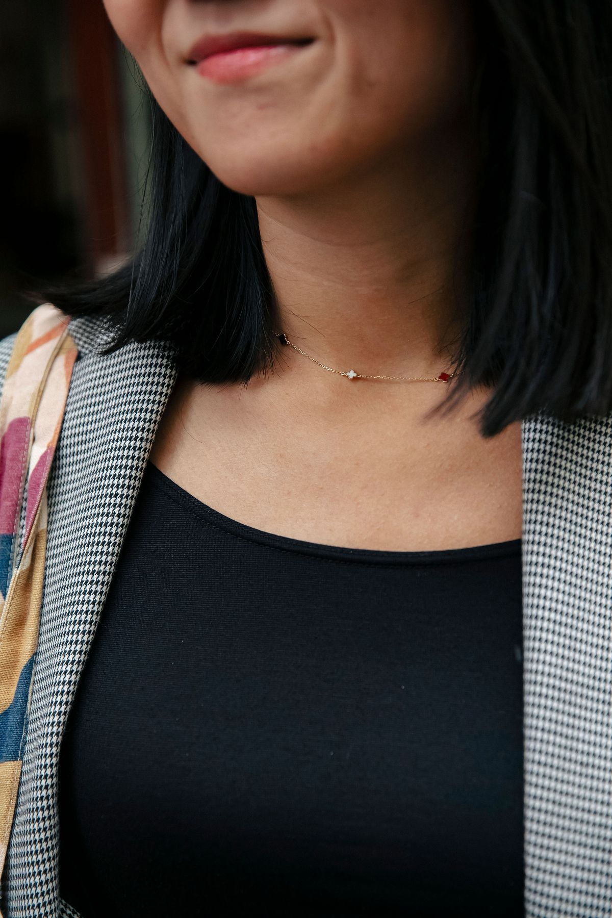 An upclose photo of a woman’s simple necklace.