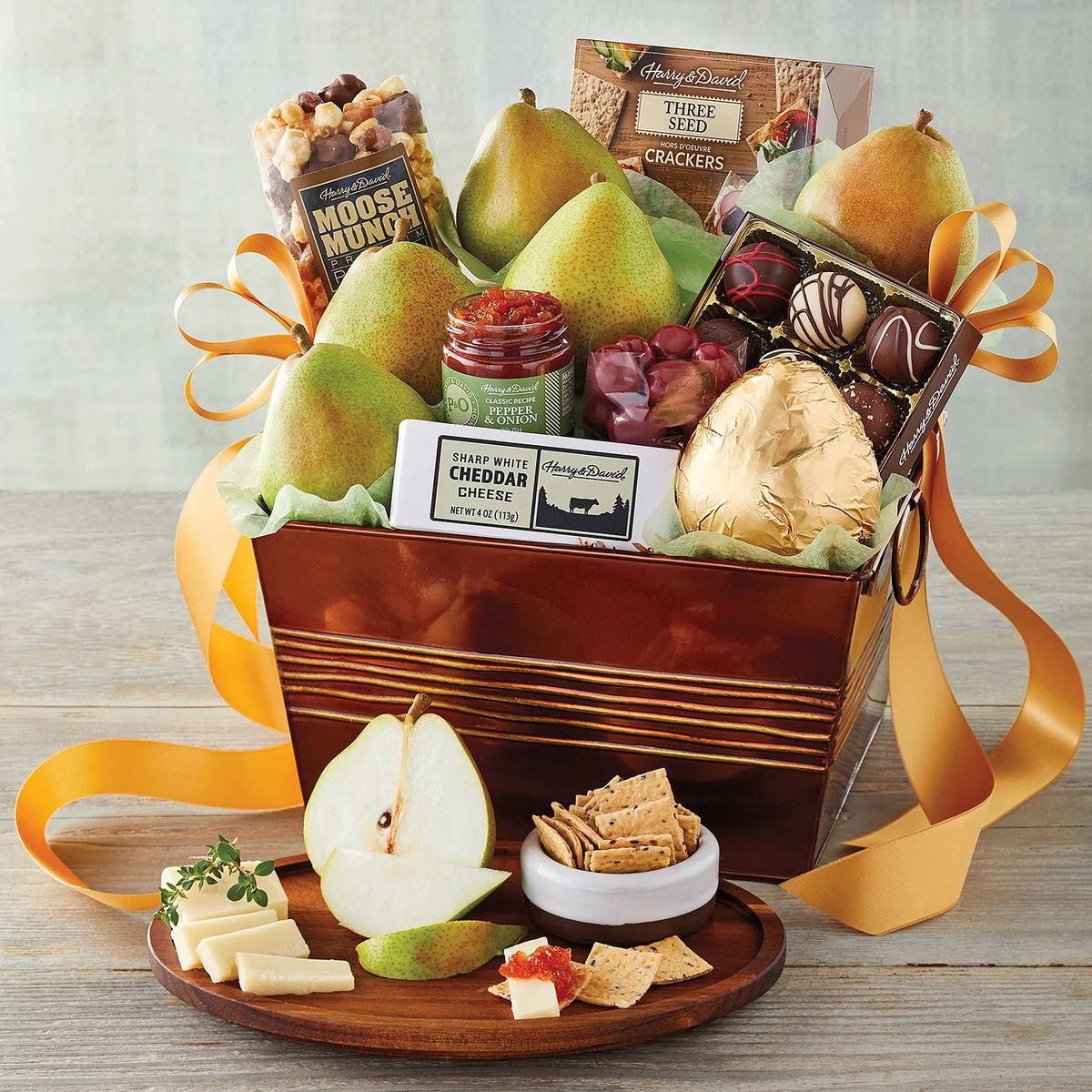 A Harry &amp; David gift basket filled with pears, chocolates, jams, and cheese
