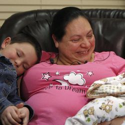 Mariah Ostler hugs her son Courtney, 6, as she shows off a healthy baby boy after delivering him on the freeway during a press conference at Brigham City Community Hospital in Brigham City Sunday, Feb. 1, 2015.
