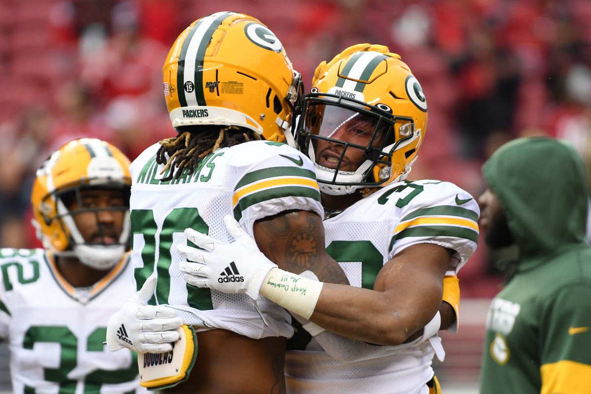 Aaron Jones #33 hugs Jamaal Williams #30 of the Green Bay Packers during warm ups prior to their game against the San Francisco 49ers in the NFC Championship game at Levi’s Stadium on January 19, 2020 in Santa Clara, California.