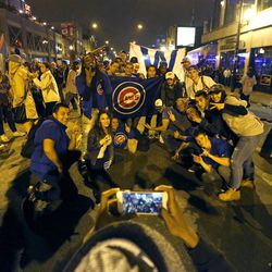 Chicago Cubs fans celebrate near Wrigley Field in Chicago on Thursday, Nov. 3, 2016, after the Cubs beat the Cleveland Indians 8-7 in Game 7 of the Major League World Series in Cleveland. (AP Photo/Charles Rex Arbogast)