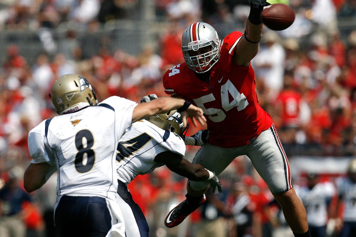 COLUMBUS, OH - SEPTEMBER 3:  John Simon #54 of the Ohio State Buckeyes jumps up and blocks a pass by Clayton Moore #8 of the Akron Zips on September 3, 2011 at Ohio Stadium in Columbus, Ohio. (Photo by Kirk Irwin/Getty Images)