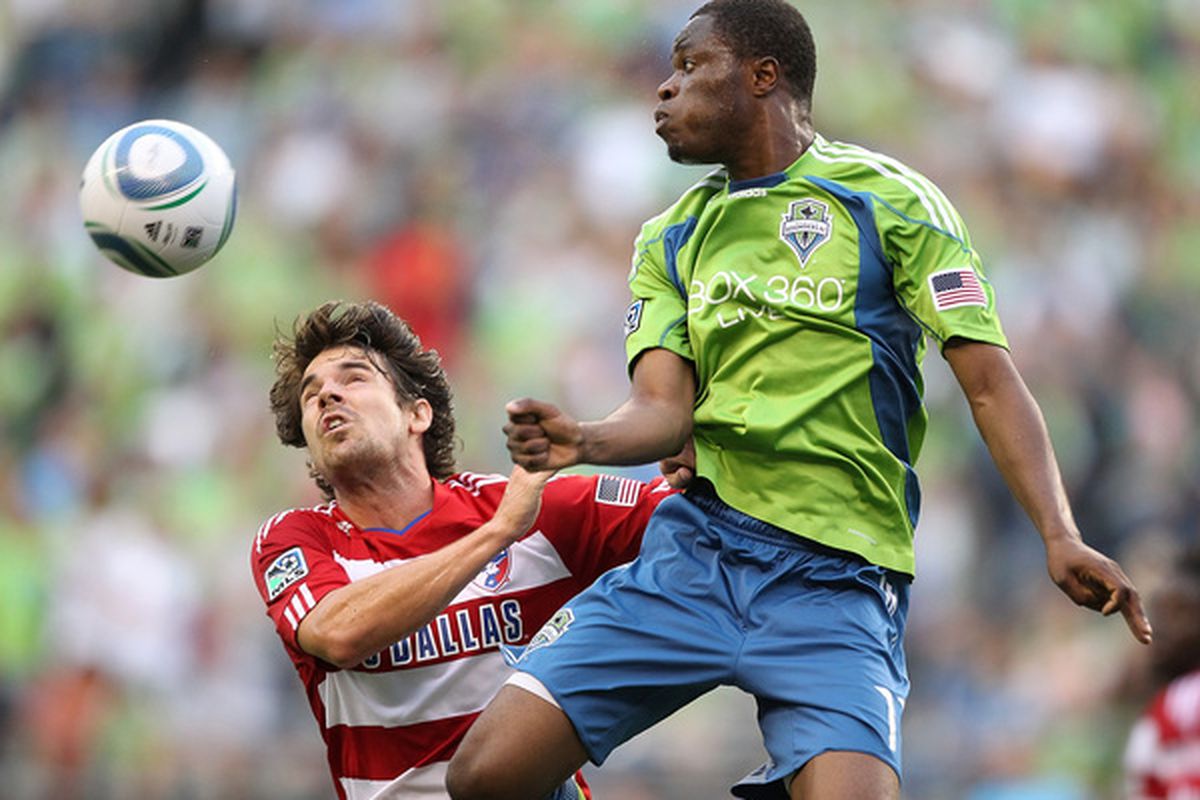 SEATTLE - JULY 11:  Steve Zakuani #11 of the Seattle Sounders FC heads the ball against Heath Pearce #4 of FC Dallas on July 11 2010 at Qwest Field in Seattle Washington. (Photo by Otto Greule Jr/Getty Images)