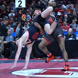 Nebraska’s Chad Red (right) wrestles Indiana’s Cayden Rooks in the first round of the Big Ten Championships Saturday at the Pinnacle Bank Arena in Lincoln.