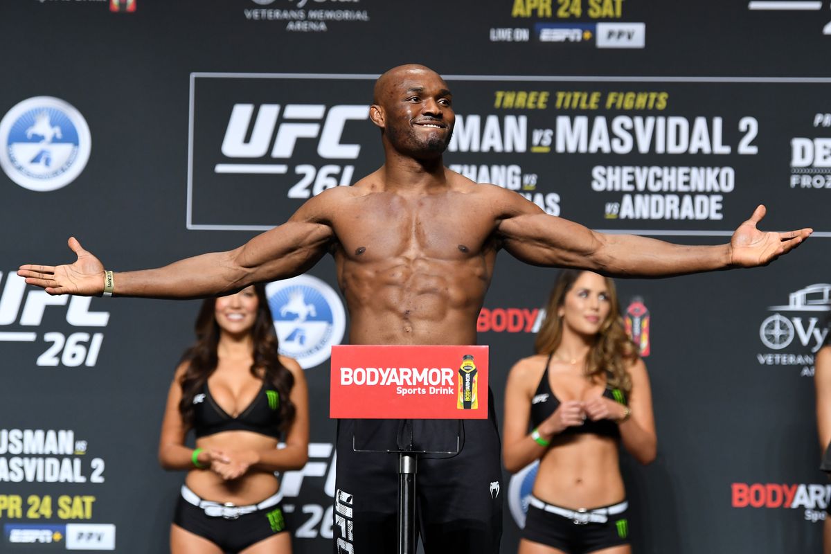 UFC welterweight champion Kamaru Usman of Nigeria poses on the scale during the ceremonial UFC 261 weigh-in at VyStar Veterans Memorial Arena on April 23, 2021 in Jacksonville, Florida.