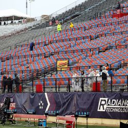 A few fans stand along the fence and watch the teams stretch out as BYU and UAB prepare to play in the Radiance Technologies Independence Bowl in Shreveport, Louisiana, on Saturday, Dec. 18, 2021.