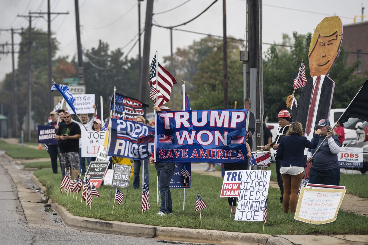 Supporters of former President Donald Trump protest on East Higgins Road near Brennan Boulevard, hours before President Joe Biden would make a speech about COVID-19 vaccine requirements at a Clayco, Inc. construction site nearby, Thursday, Oct. 7, 2021.