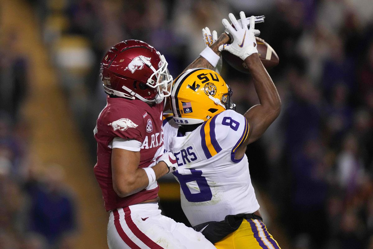 Arkansas Razorbacks defensive back Myles Slusher (2) breaks up a pass intended for LSU Tigers wide receiver Malik Nabers (8) in the first half at Tiger Stadium.