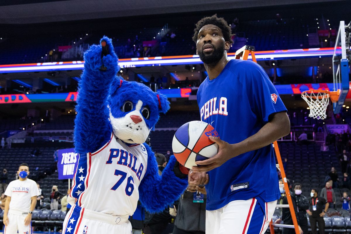Philadelphia 76ers center Joel Embiid is given a game ball by mascot Franklin after a victory against the Orlando Magic at Wells Fargo Center.&nbsp;