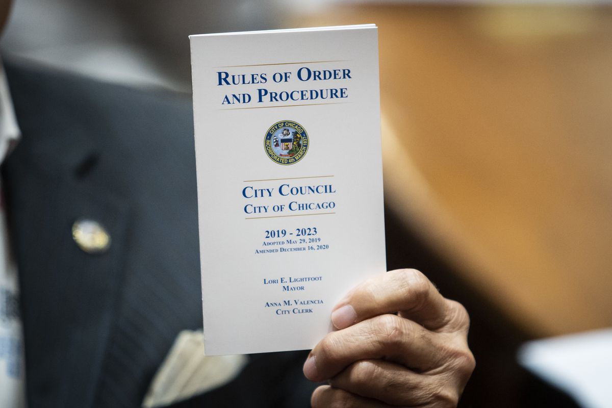 Ald. Ariel Reboyras (30th) holds up a copy of the “Rules of Order and Procedure” of the City Council during a Council meeting at City Hall on Wednesday, June 23, 2021. 
