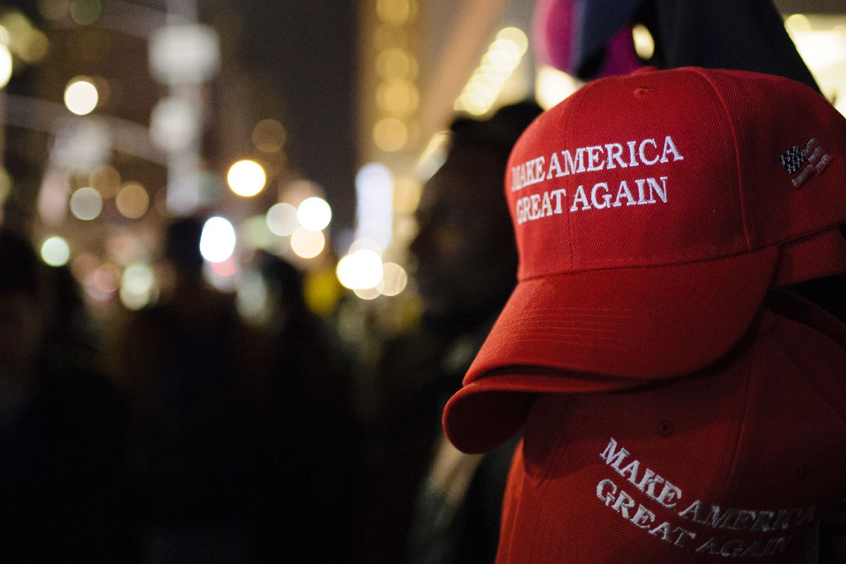A stack of “Make America Great Again” red baseball caps.
